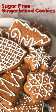 gingerbread cookies with white icing are on a plate and the words, sugar free gingerbread cookies