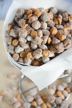 a white bowl filled with lots of different types of dog treats on top of a table