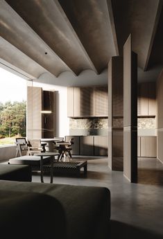 a living room filled with furniture next to a kitchen and dining area in front of a large window