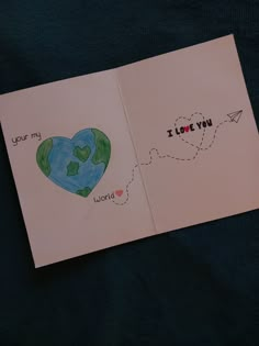 an open book with a drawing of a heart and the words i love you on it