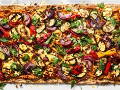 an overhead view of a pizza with vegetables and herbs on it, ready to be eaten