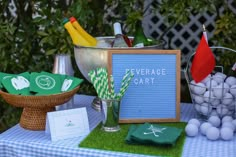 a table topped with golf themed items and a sign that says beverage cart on it