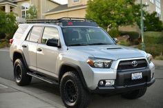 a silver toyota truck parked on the side of the road