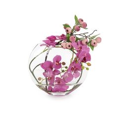 a glass vase filled with pink flowers on top of a white table