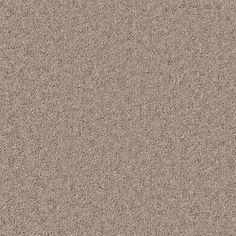 a close up view of the surface of a beige carpet with small speckles