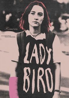 a woman with long red hair wearing a black shirt and vest that says lady bird