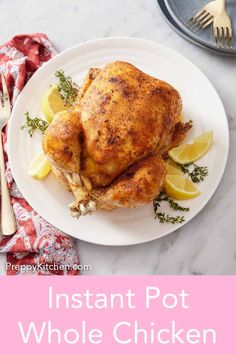 instant pot whole chicken on a white plate with lemon wedges