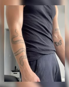 a man with a snake tattoo on his arm