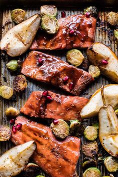 salmon and brussel sprouts on a baking sheet with potatoes, brussels sprouts and pears