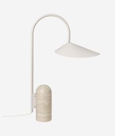 a white table lamp with a concrete base