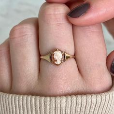 A dainty 1970s shell cameo ring set on a 9k gold band. All vintage rings are one-off, high-quality pieces that have been pre-loved. A sustainable choice, they are designed to last a lifetime. BAND: 9k solid gold. STONE: shell. SIZE: UK N, US 6.5 (we do not re-size, please contact your reputable local jeweller). HALLMARKS: hallmarked Birmingham 1973, 9 carat gold. SHIPPING: all vintage rings come with complimentary shipping. GIFTING: all rings come packaged in our signature gift box. RETURNS: 16 Vintage Gold Ring, Gold Promise Ring, Vintage Gold Rings, Cameo Ring, Vintage Cameo, Ring Antique, Ring Vintage, Promise Ring, Rings Statement