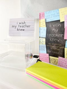 several post it notes are stacked on top of each other in front of a blackboard