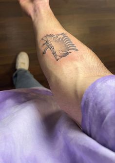 a man's foot with a tattoo on his left leg and palm tree in the middle