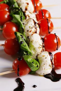 the skewers have tomatoes, mozzarella and lettuce on them