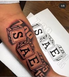 a person with a black and white tattoo on their arm that has blocks in the shape of letters