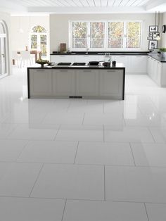 a kitchen with white tile floors and counter tops