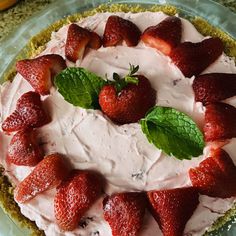 a pie with strawberries and mint leaves on top