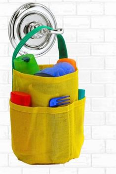 a yellow bag with some toys in it and a faucet on the wall