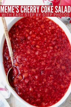 a white bowl filled with cranberry sauce next to two cans of soda and a spoon