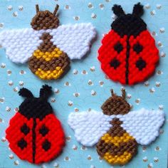 four little ladybug brooches on a blue background