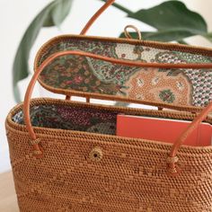 The Bali Rattan Tote Bag With Lid is the perfect accessory for any stylish woman. This beautiful, handmade rattan bag is made by skilled artisans in Bali, using natural materials to create a one-of-a-kind piece that is both fashionable and functional. The tote design and lid make it the perfect bag for everyday use, while the natural rattan adds a touch of elegance to any outfit. Whether you're headed to the office or the beach, the Bali Rattan Tote Bag With Lid is the perfect addition to your w Luxury Summer Bag With Bamboo Handle, Luxury Summer Bags With Bamboo Handle, Luxury Rectangular Straw Bag With Removable Pouch, Luxury Eco-friendly Shoulder Bag With Bamboo Handle, Luxury Straw Satchel Bag, Luxury Natural Shoulder Bag With Bamboo Handle, Luxury Casual Bag With Bamboo Handle, Luxury Shoulder Bag With Bamboo Top Handle, Luxury Bags With Bamboo Handle And Top Handle