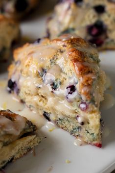 blueberry muffins with icing on a white plate