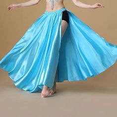 a woman in a blue dress is dancing