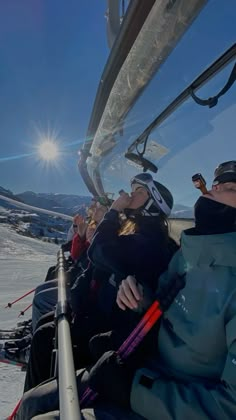 people sitting in the back of a ski lift