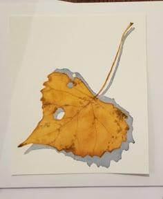 a piece of paper with a leaf on it