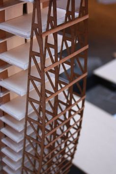 a close up of a model of a building made out of wood and white tiles