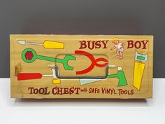 a wooden toy box with tools in it