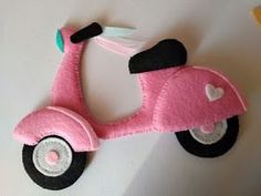 a pink toy scooter sitting on top of a table