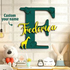 there is a wooden sign with the letter f on it and a teddy bear next to it