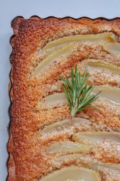 an apple tart with some rosemary sprig on top