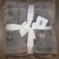 a blanket with a white ribbon tied around it