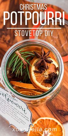 christmas potpouri in a glass jar with an orange slice and cinnamon on top