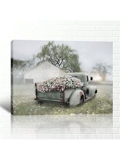 an old truck with flowers in the back