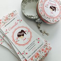 three small round tins sitting next to each other on top of a white table