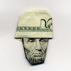 a dollar bill with a man's face wearing a hat on top of it