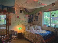 a bed room with a neatly made bed and lots of lights hanging from the ceiling