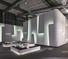 an exhibition room with white walls and lights