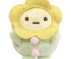 a small stuffed animal with a yellow flower on it's head and green body