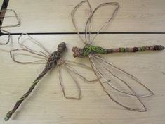 three dragonflies sitting on top of a wooden table