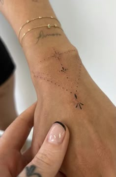 a woman's hand with tattoos on it