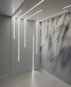 an empty room with palm leaves painted on the wall and wooden flooring in front of it