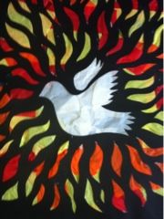 a white bird with red, yellow and green feathers on it's wings is surrounded by flames