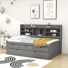 a bedroom with a bed, bookcase and rugs on the hardwood flooring