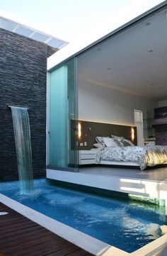 a bedroom with a pool in front of it