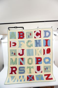 an alphabet quilt hanging on the wall