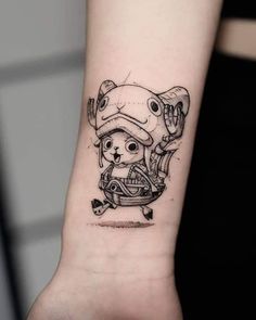 a small tattoo on the wrist of a person wearing a hat and holding a baseball bat